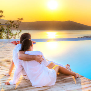 Couple in hug watching together sunrise in Greece